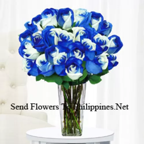 24 Mixed Tone (Blue And White) Roses With Some Ferns In A Glass Vase