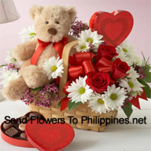 A Beautiful Basket Made Of Red Roses, White Gerberas And Seasonal Fillers, An Imported Box Of Chocolate And A Cute Brown Teddy Bear