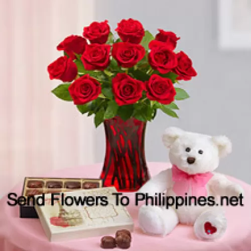 12 Red Roses With Some Ferns In A Glass Vase, A Cute 12 Inches Tall White Teddy Bear And An Imported Box Of Chocolates