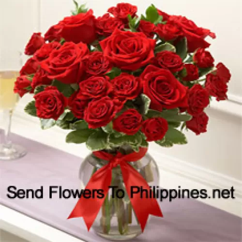 36 Red Roses With Some Ferns In A Glass Vase