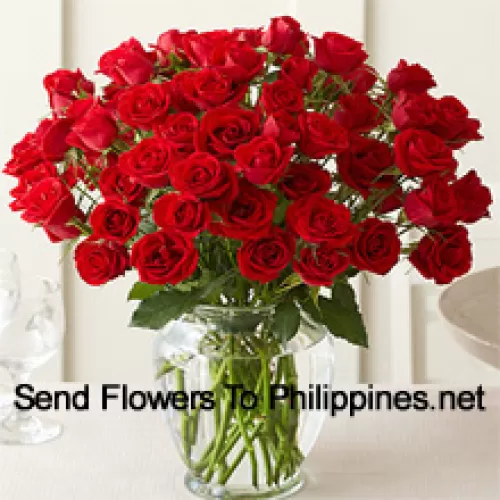 50 Red Roses With Some Ferns In A Glass Vase