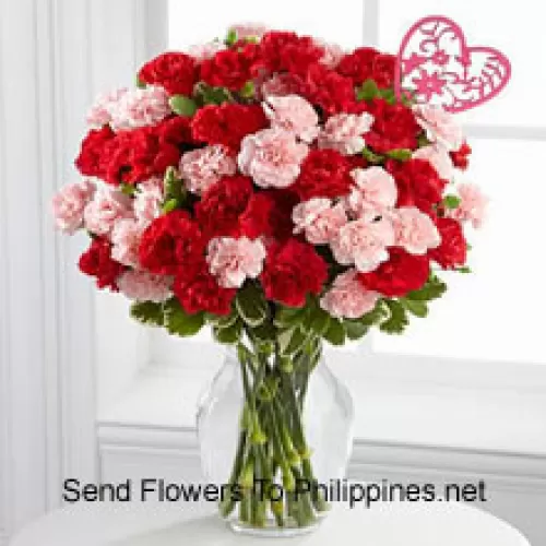 37 Carnations ( 18 Red And 18 Pink ) With Seasonal Fillers And Heart Stick In A Glass Vase